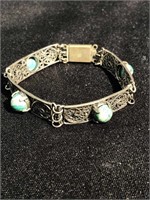 Fine filigree bracelet with green and white