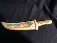 Knife hand made from bovine bone etched with