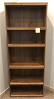Oak colored bookcase and contents