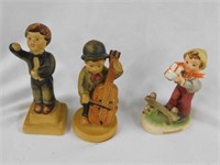 Three boy figures: cello player & conductor are