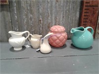 Assorted pottery pitchers, pink glass covered dish