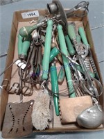 Assorted green handle kitchen utensils