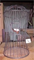 Metal bird cage with ornamental bird