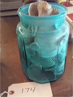 vintage blue cannister jar full of seashells