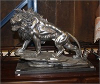 Silver painted resin sculpture of a roaring