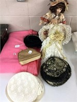 Group of hats, porcelain doll, flannel blanket,