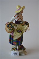 Antique porcelain figurine of a flower seller