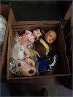 Box of dolls dolls pieces and camera