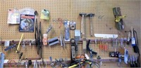 Entire contents of pegboard wall: several hammers,