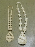 Two bone elephant pendant necklaces, 17" & 21"