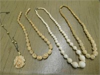 Two carved bone necklaces - 1 smooth bead