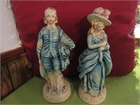 2 Figurines 10"Tall Each Chip on Hat of Lady
