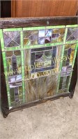 Antique stained glass window with old varnish
