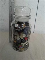 Glass jar full of buttons with lid