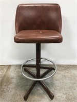 Swiveling brown bar stool