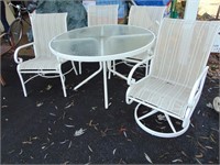 ROUND GLASS TOP TABLE AND 4 CHAIRS 1 SWIVEL