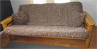 Wood futon. Measures 74" long.