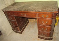 Antique wood desk with nine drawers. Measures 30"