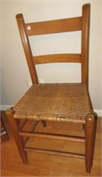 Antique wood chair with woven seat.