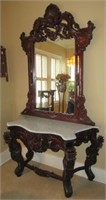Heavily carved wood entry stand with mirror and