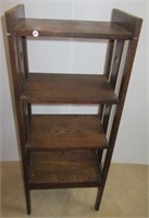 Four tier wood stand. Measures 44" h x 17.5" w x