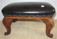 Antique wood footstool with leather top.