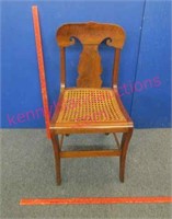 old t-back caned chair