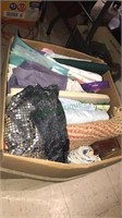 Large boxes of fabric, sheets, a rug, placemats