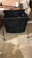 Folding canvas laundry cart with three sections,