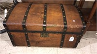 Antique wooden trunk with metal straps in the