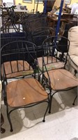 Set of four heavy iron arm chairs with wooden