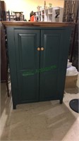 Pine kitchen pantry cabinet with the dark green