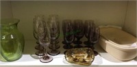 Shelf lot with purple wine glasses, clay cook pot