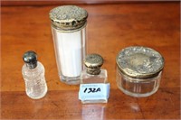 4 TOILETRY GLASS BOTTLES WITH STERLING LIDS