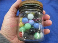 4in tall bottle of old marbles