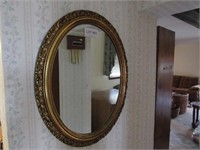Gold frame oval mirror