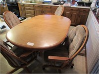 Oak oval kitchen table, four roll chairs