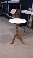 Marble pedestal table with a chip