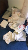 Lot of assorted linens, doilies, and tablecloths