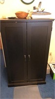 Black two door entertainment cabinet with contents