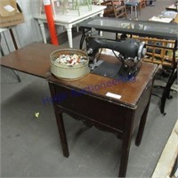 Electric sewing machine w/cabinet-button