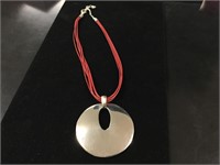 Large Silver Pendant On Red Cord