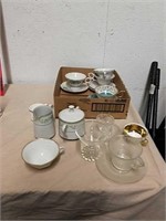 Group of teacups and saucers and cream and sugar