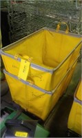 Two yellow rolling laundry carts