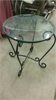 Round glass top iron base side table.
