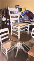 Pedestal table in four matching chairs with rush