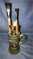 Stein full of paintbrushes, closed end wrench and
