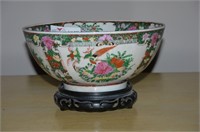 Reproduced rose medallion bowl on teak wood