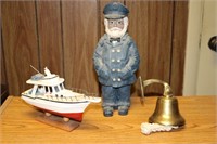 Brass bell, old sea captain figurine and a wooden