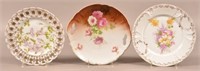 Three Porcelain Floral Decorated Plates. Largest